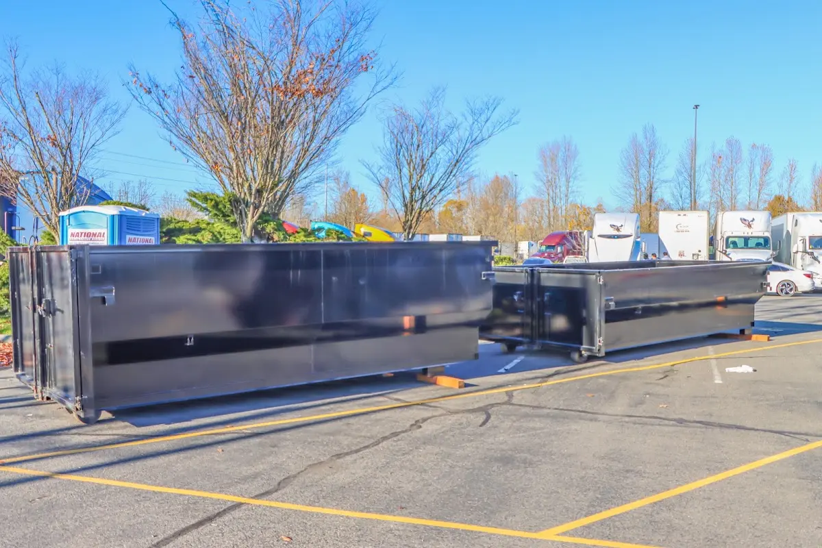 Professional dumpster rental service with roll-off container on residential driveway in North Berwick